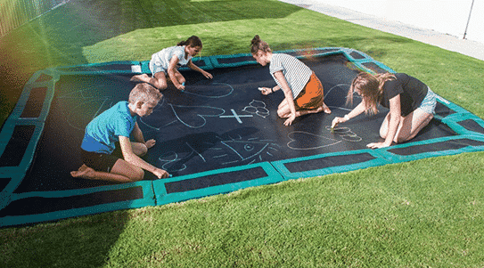 Kids playing on in-ground trampoline