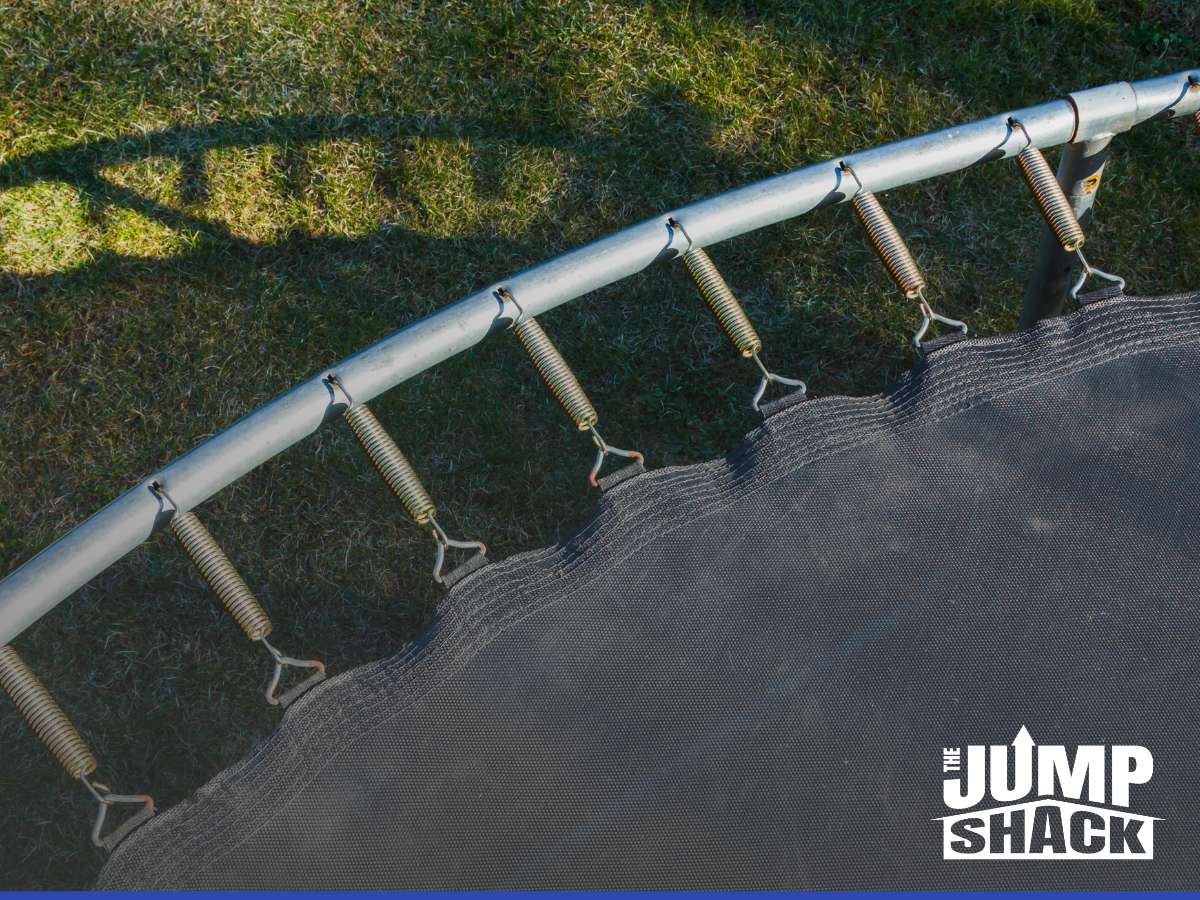 Close-up of trampoline parts and accessories, focusing on springs and jumping mat